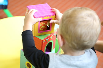Toddler stacking colorful educational blocks