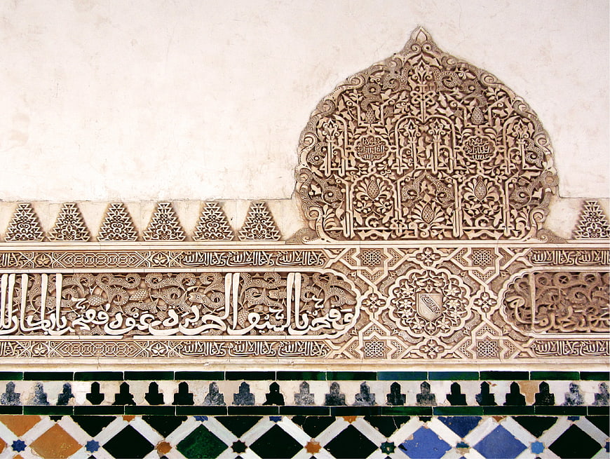 Intricate Islamic Stucco Carvings And Geometric Tilework At The Alhambra