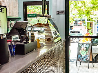 Coffee Shop Counter with Pastries and POS System