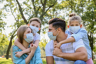 Family with Face Masks in Park
