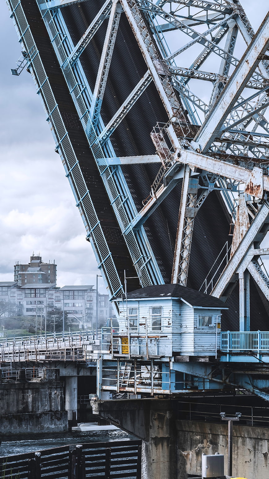 Blue Drawbridge Raised Over River With Control House