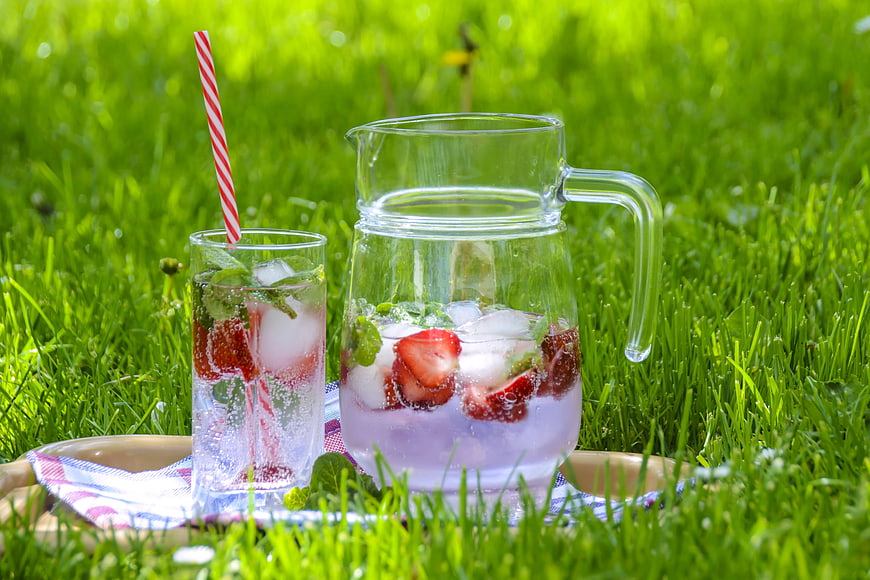 Refreshing Strawberry Mint Drink on Green Grass