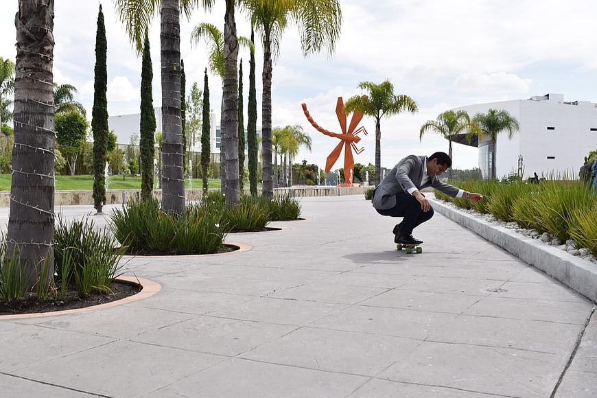 Businessman Skateboarding in Modern Corporate Park