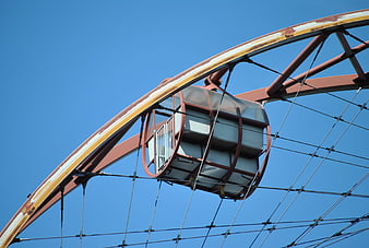 Industrial Ferris Wheel Cabin Against Blue Sky