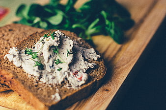 Rustic Whole Wheat Bread with Creamy Herb Spread on Wooden Board