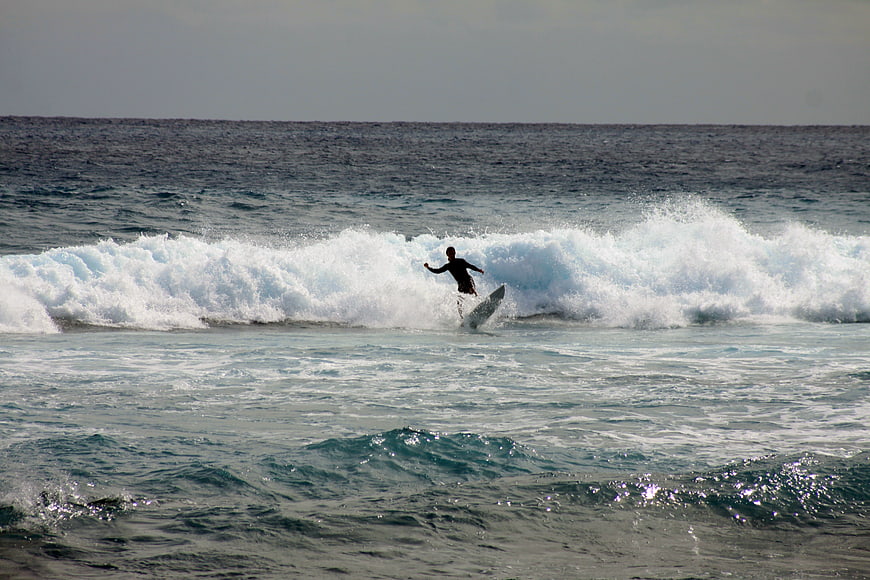 Surfer riding a wave in the ocean