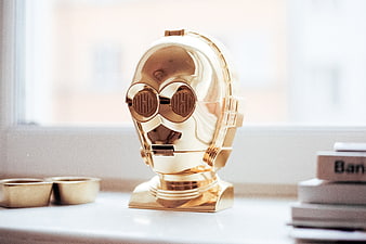 Gold C-3PO Robot Head Sculpture on White Table