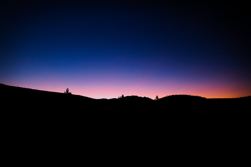 Silhouette of mountain ridge against twilight sky