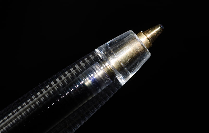 Macro Close-Up of Ballpoint Pen Tip on Black Background