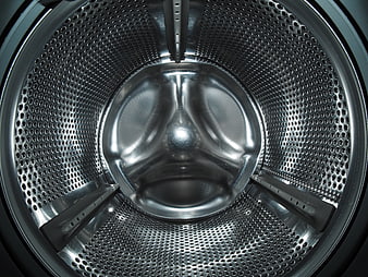 Close-up of empty stainless steel washing machine drum interior