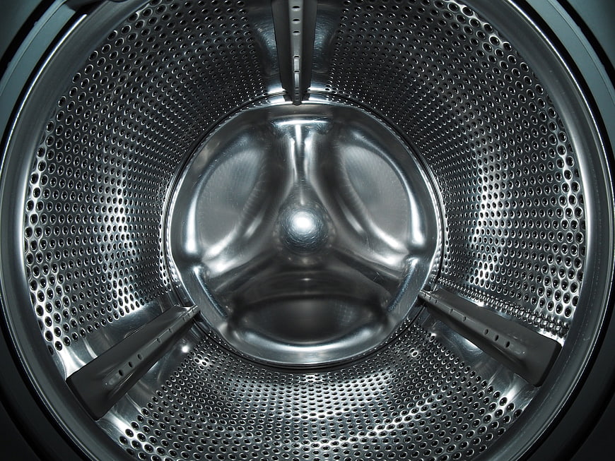 Close-up of empty stainless steel washing machine drum interior