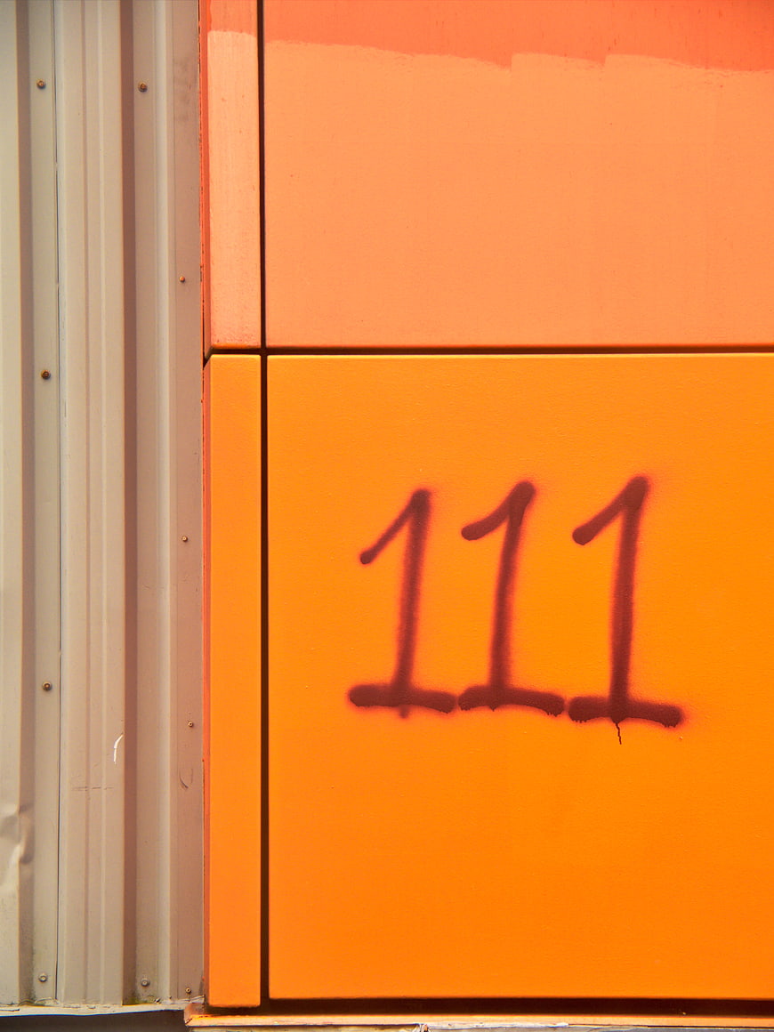 Orange Wall with Spray Painted Number 111