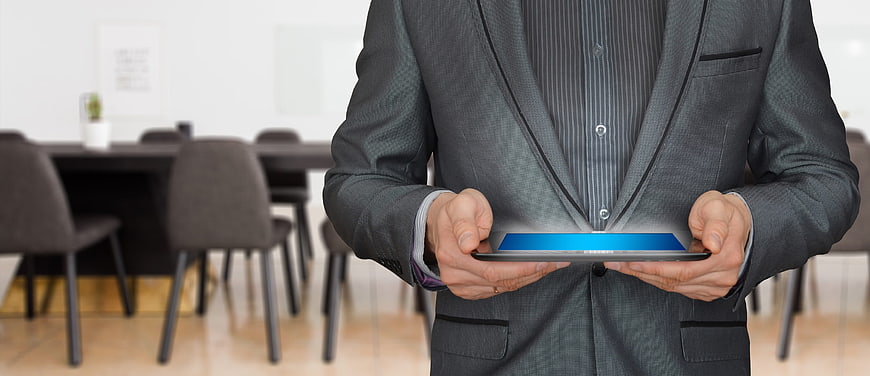 Businessman in Suit Holding Tablet in Modern Office