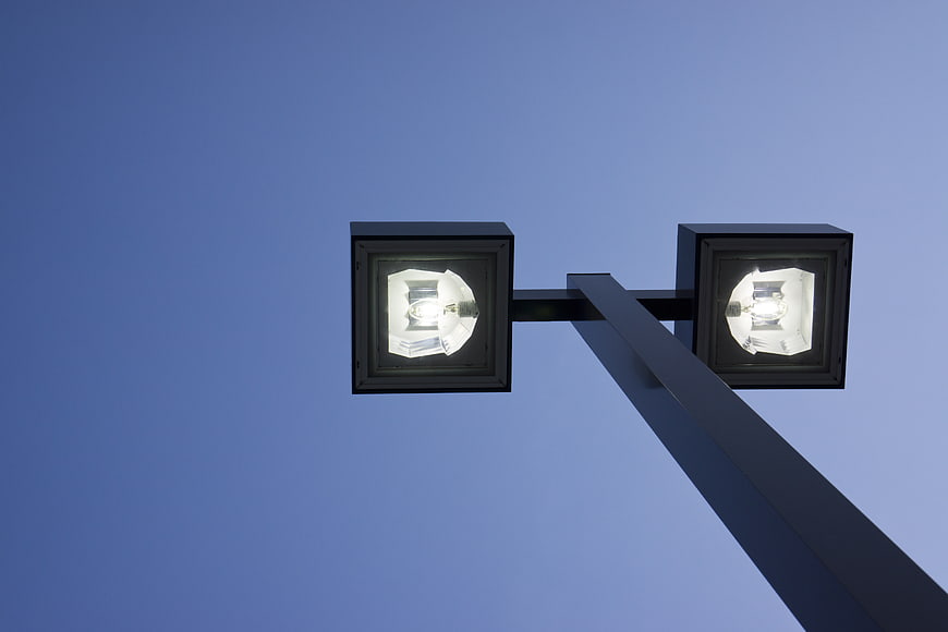 Low angle view of modern street lamp against blue sky