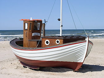 Traditional Wooden Fishing Boat on Sandy Beach
