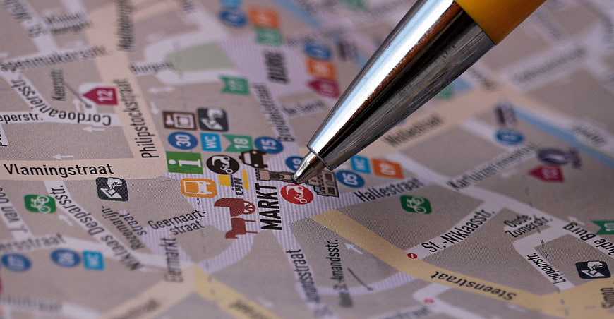 Pen Pointing at City Map Market Location