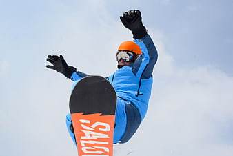 Snowboarder in mid-air jump against blue sky