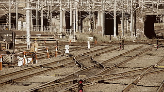 Railway Worker Standing on Complex Train Tracks