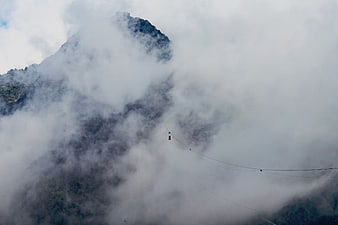 Cable Car Suspended in Thick Mountain Fog