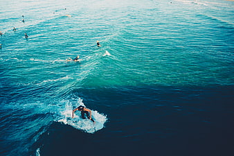 Aerial View of Surfer Riding a Wave in the Ocean