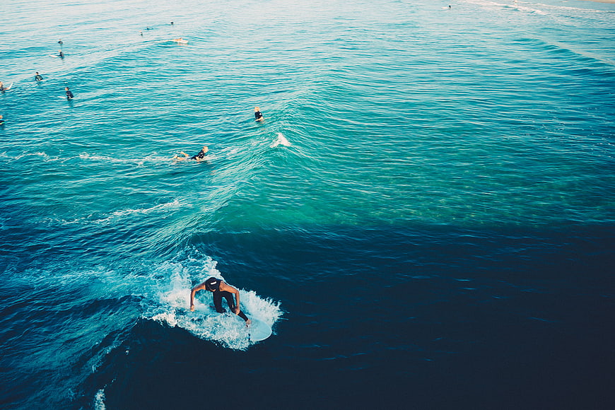 Aerial View of Surfer Riding a Wave in the Ocean