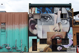 Large Colorful Mural of a Woman's Face on Urban Building