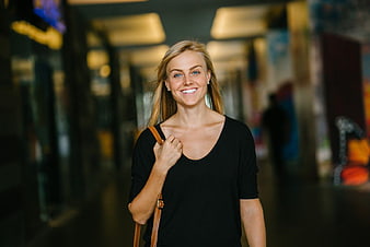 Smiling Blonde Woman Walking in Shopping Mall