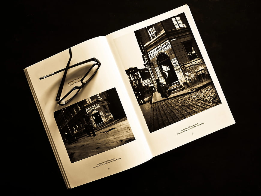 Vintage Sepia Photo Album with Glasses on Black Background