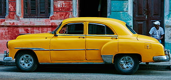 Vintage Yellow Classic Car Parked on Colorful Street