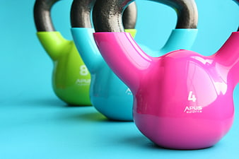 Colorful Kettlebells on Blue Background for Fitness