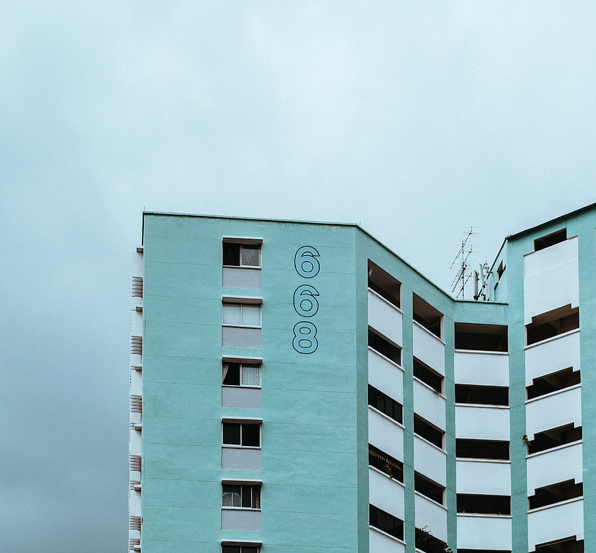 Minimalist Teal Apartment Building with Number 668