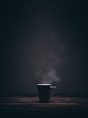 Steaming Coffee Mug on Dark Wooden Table with Dramatic Smoke