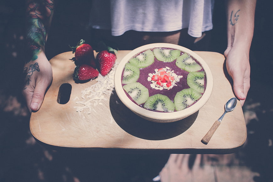 Acai Bowl with Kiwi and Strawberries on Wooden Tray