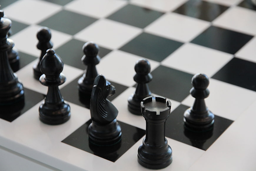 Close-up of black chess pieces on a checkered board