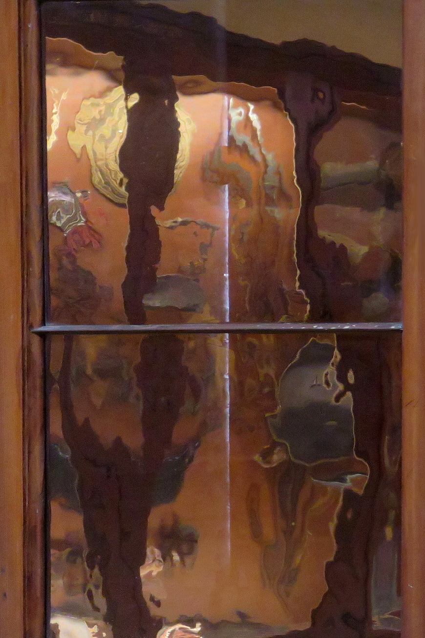 Abstract warped window reflection with distorted brown and orange tones