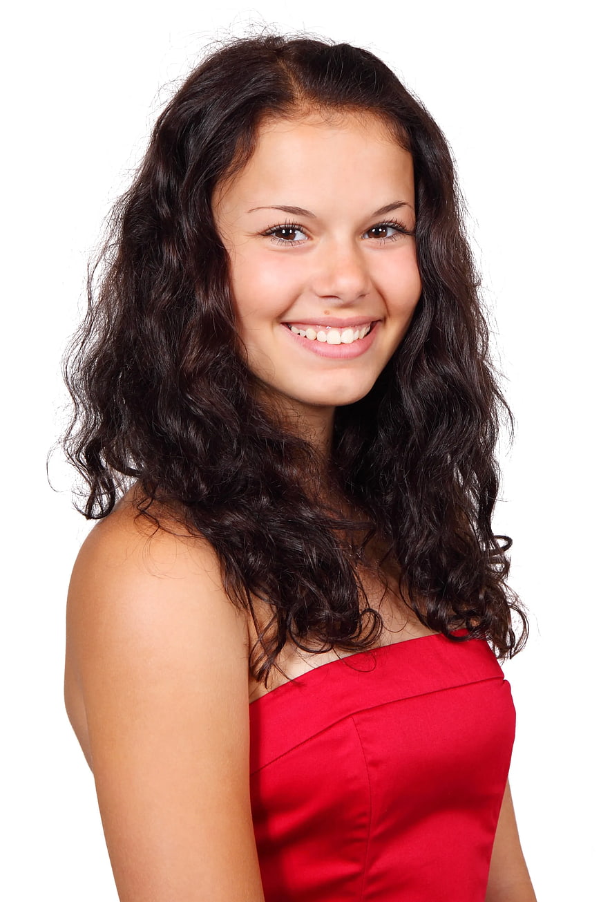 Smiling Woman with Dark Wavy Hair in Red Dress