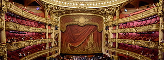 Grand Opera House Interior with Red Curtains and Gold Balconies