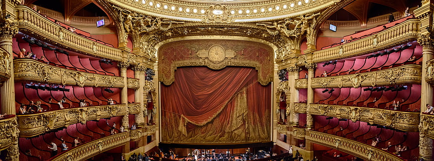 Grand Opera House Interior with Red Curtains and Gold Balconies