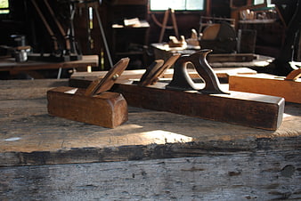 Vintage wooden hand planes on rustic workbench
