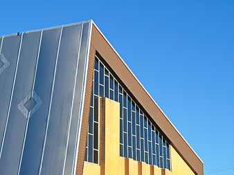 Modern industrial building facade with blue sky background