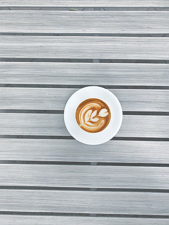 Top view of latte art coffee on gray wooden table