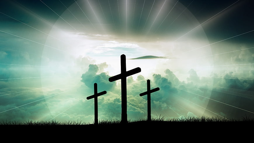 Three Crosses Silhouette Against Dramatic Cloudy Sky