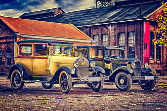 Vintage Ford and Citroen Classic Cars Parked in Front of Historic Brick Building