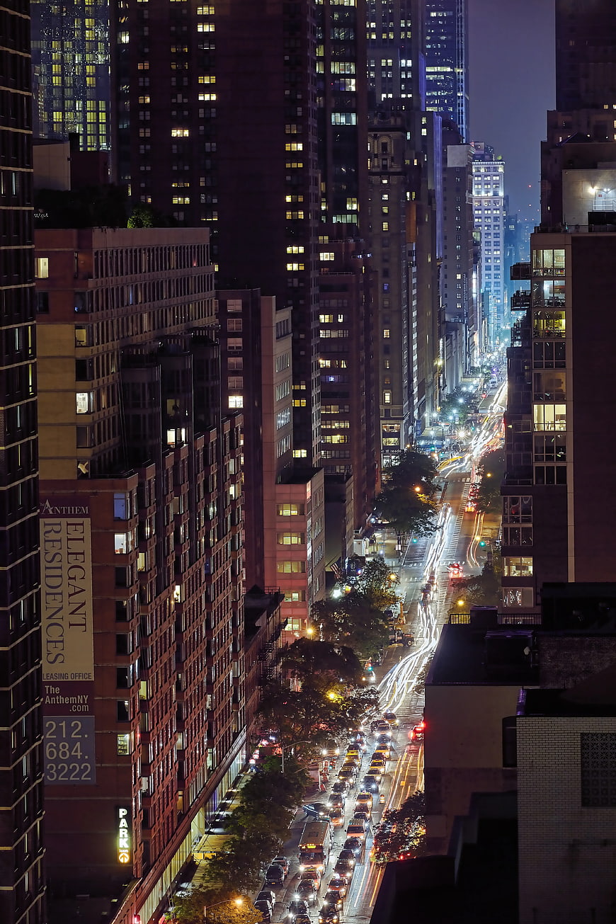Night cityscape with light trails and skyscrapers