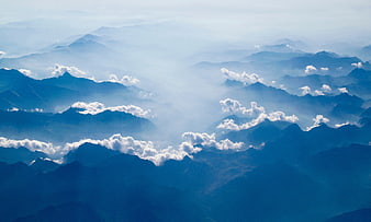 Majestic Blue Mountain Ranges with Clouds and Mist