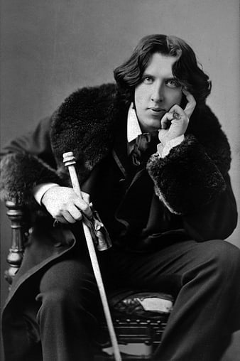 Vintage black and white portrait of Oscar Wilde in fur coat