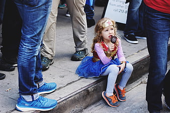 Little Girl in Wonder Woman Costume Eating Ice Cream