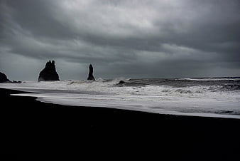Dramatic Black Sand Beach with Sea Stacks and Stormy Sky