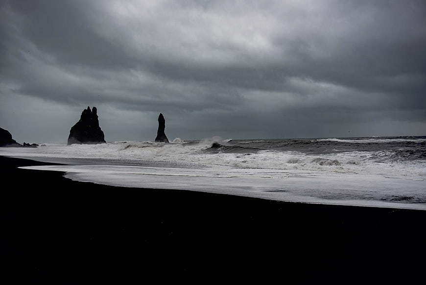 Dramatic Black Sand Beach with Sea Stacks and Stormy Sky