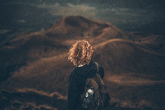 Hiker with Backpack Looking at Mountain Landscape